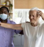 male-social-worker-taking-care-old-woman